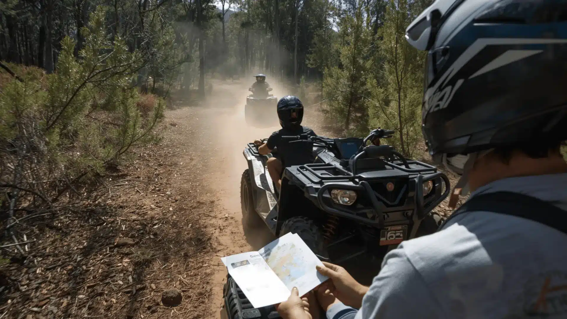 A man examines a map while riding an ATV, planning his route on approved trails for off-road vehicle rentals