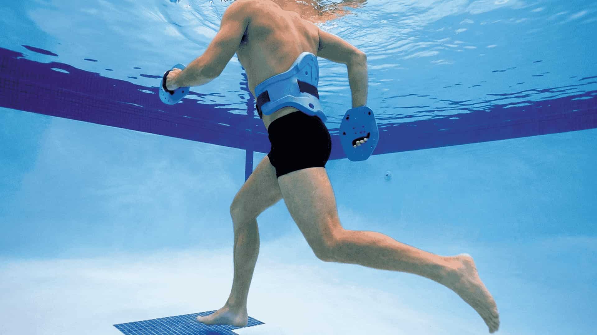 Runner aqua jogging in deep pool with flotation belt, upright posture, active arm swing, low-impact water running workout.