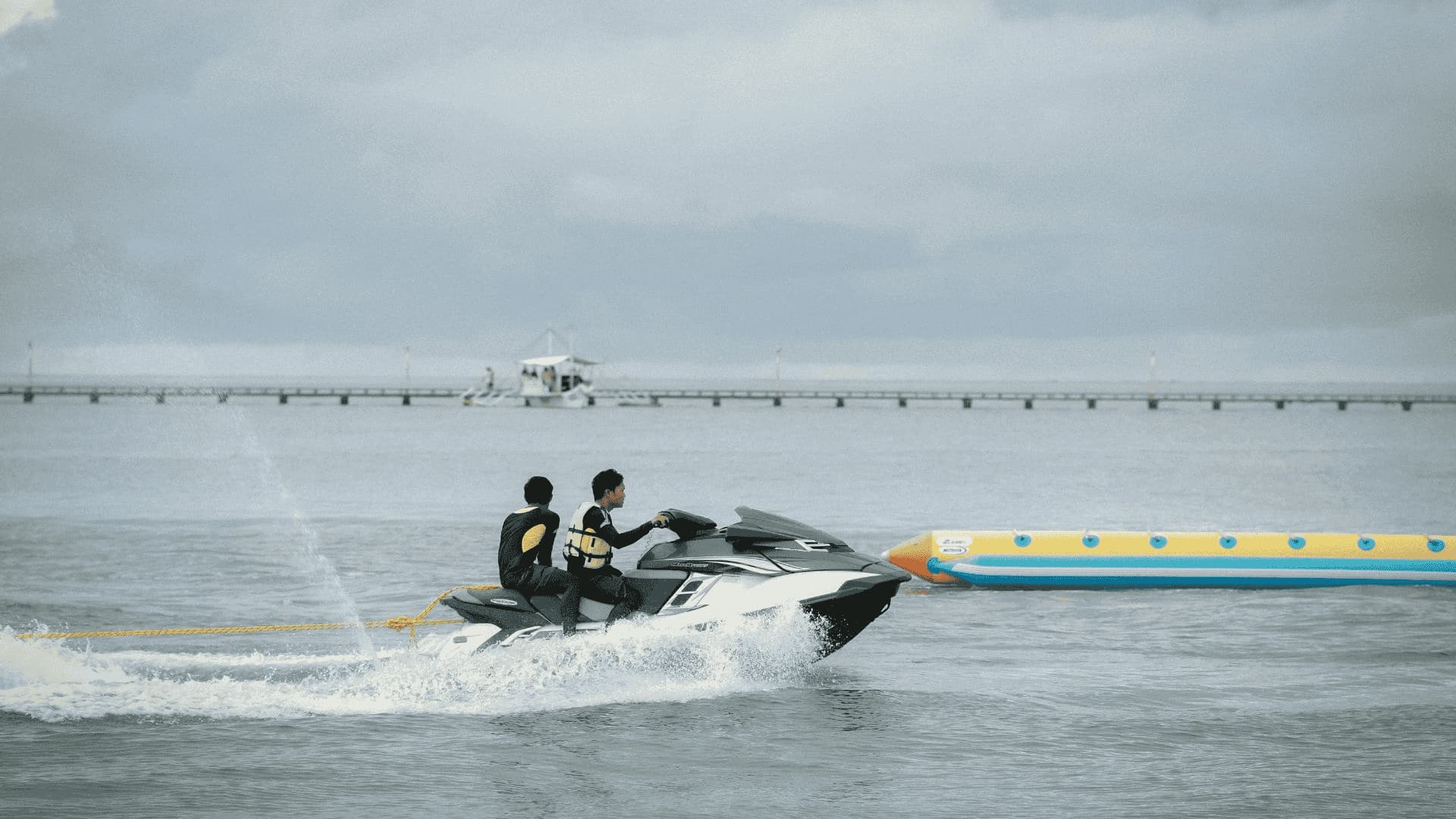Two riders on jet ski are speeding across the water, highlighting risks tied to violating jet ski age laws.