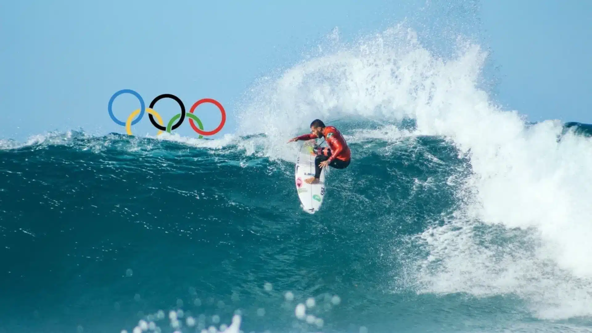 A surfer riding an ocean wave who participated in the Tokyo Olympics 2020