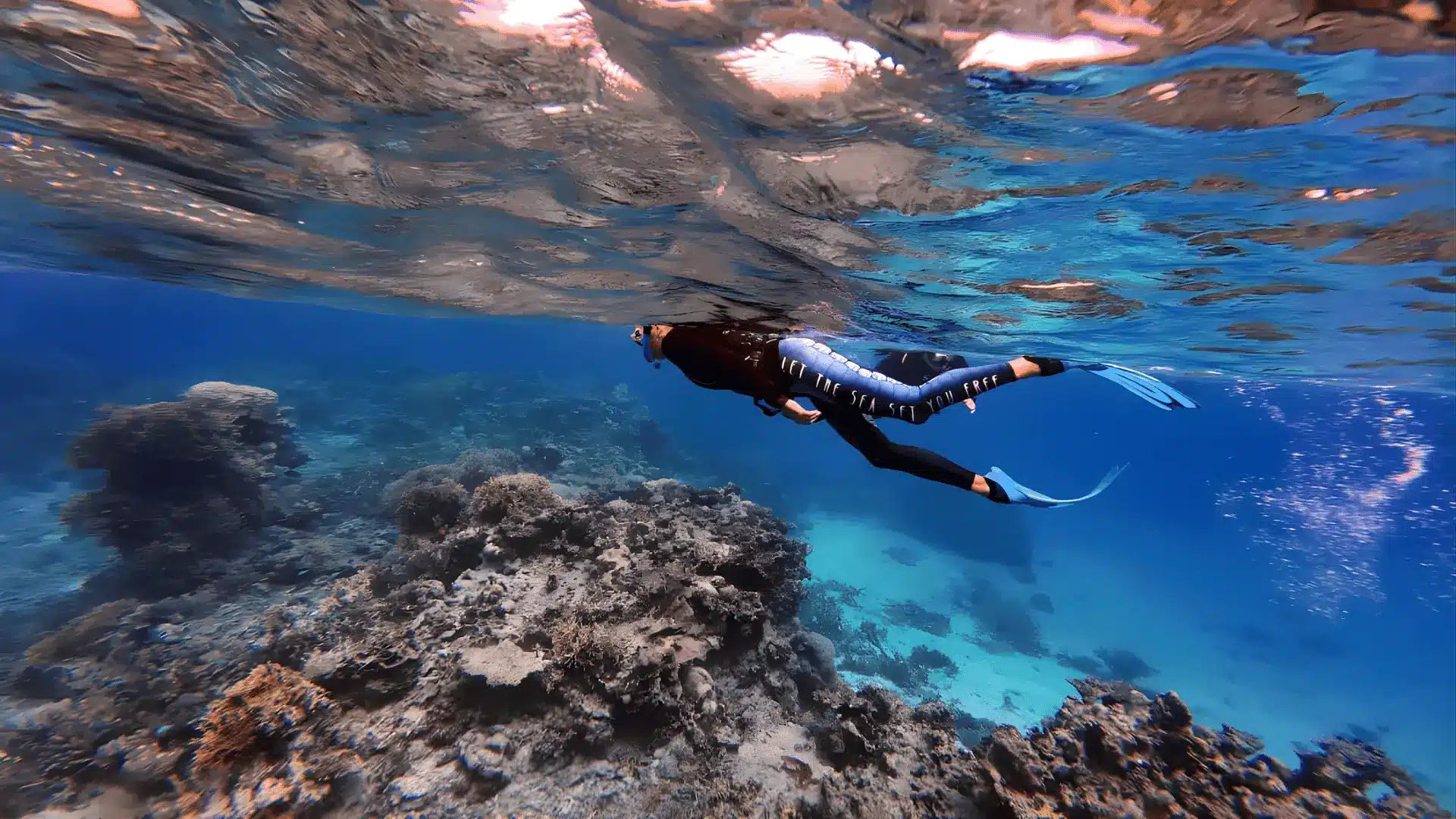 An individual in the ocean with a scuba mask, engaged in snorkeling and learning to avoid common beginner mistakes
