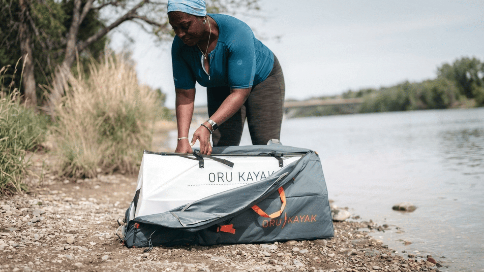 woman packing portable oru lake kayak