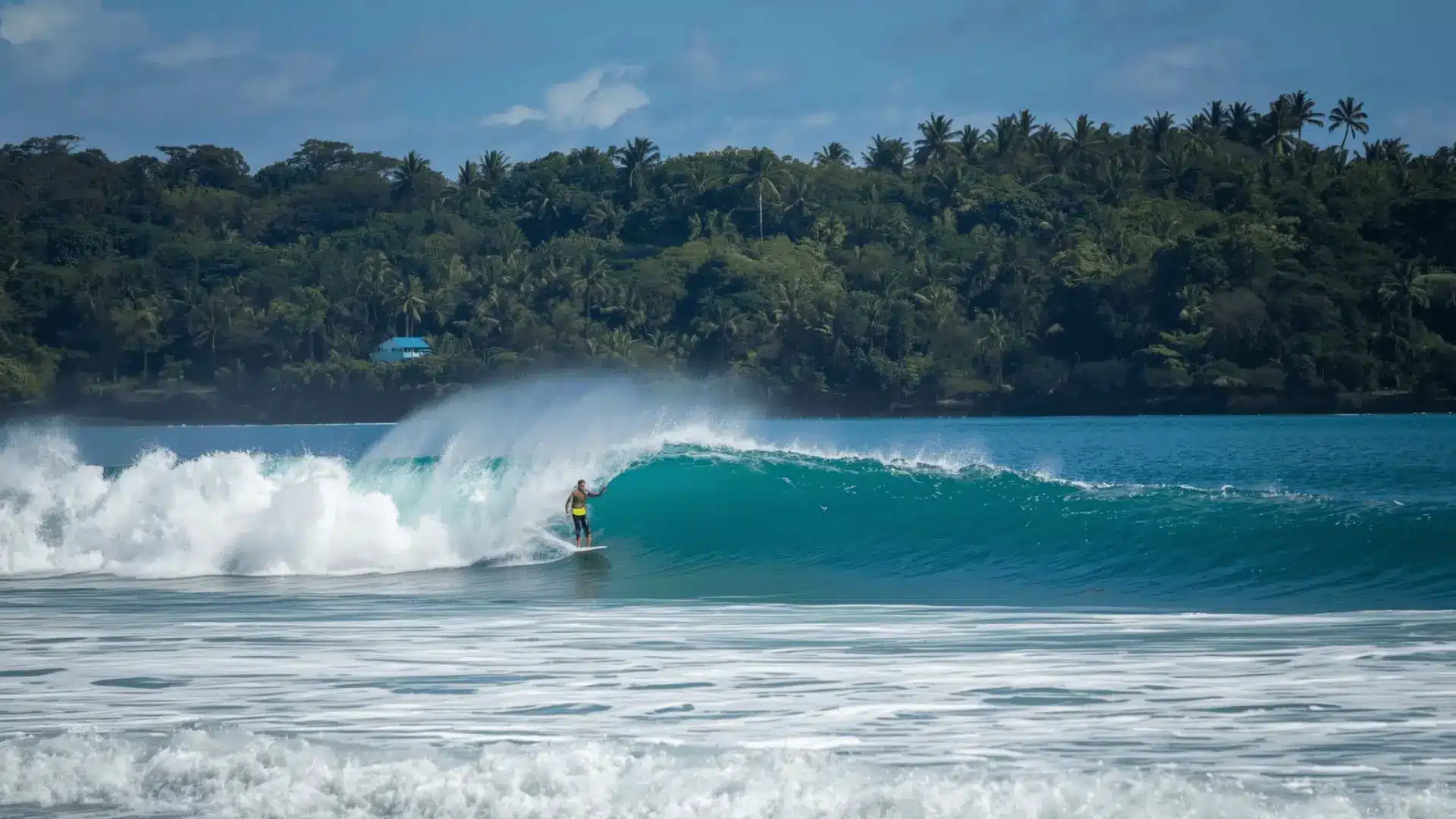 A surfer skillfully rides a wave in the ocean, showcasing the excitement of surfing in Costa Rica.
