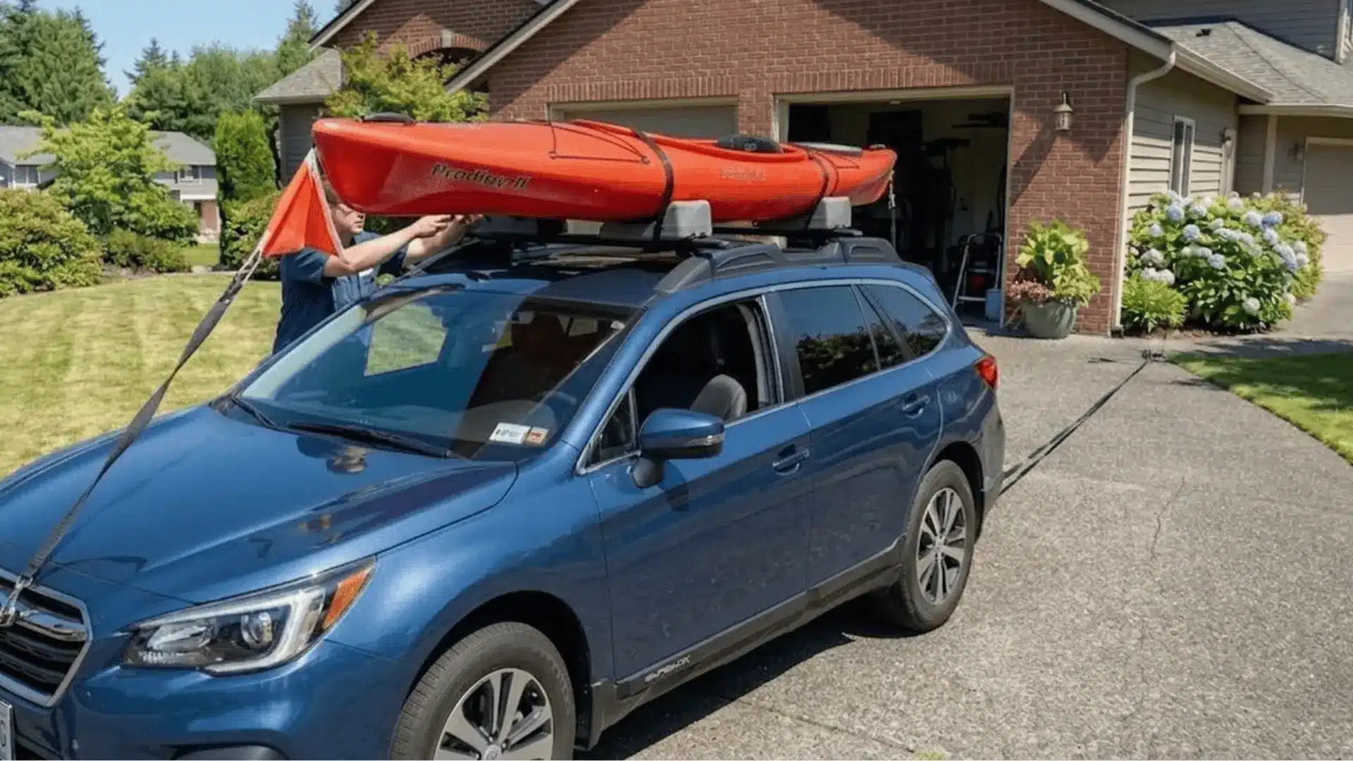 Person-Securing-Kayak-On-Roof-With-Cam-Buckle-Straps