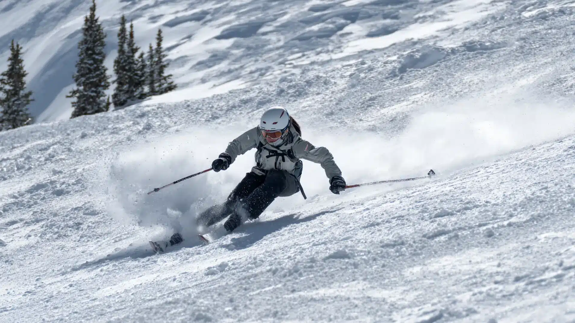 Telemark skier making deep lunge turn on open snowy slope in mountain light