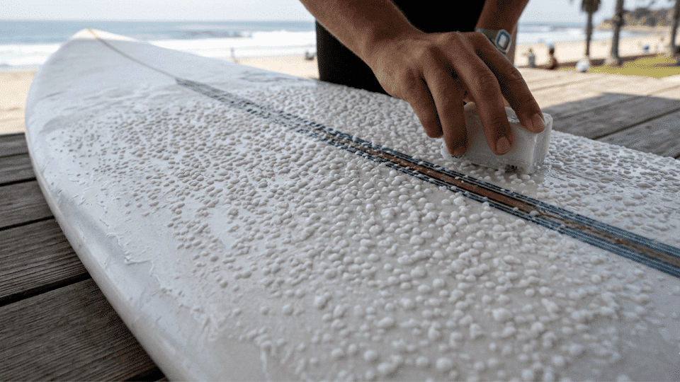 Surfboard with temperature-specific wax creating small beads on the deck for added traction.
