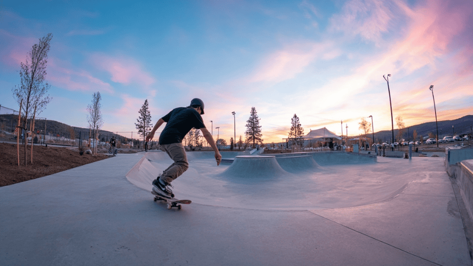 A skateboarder practicing skating in a skate park