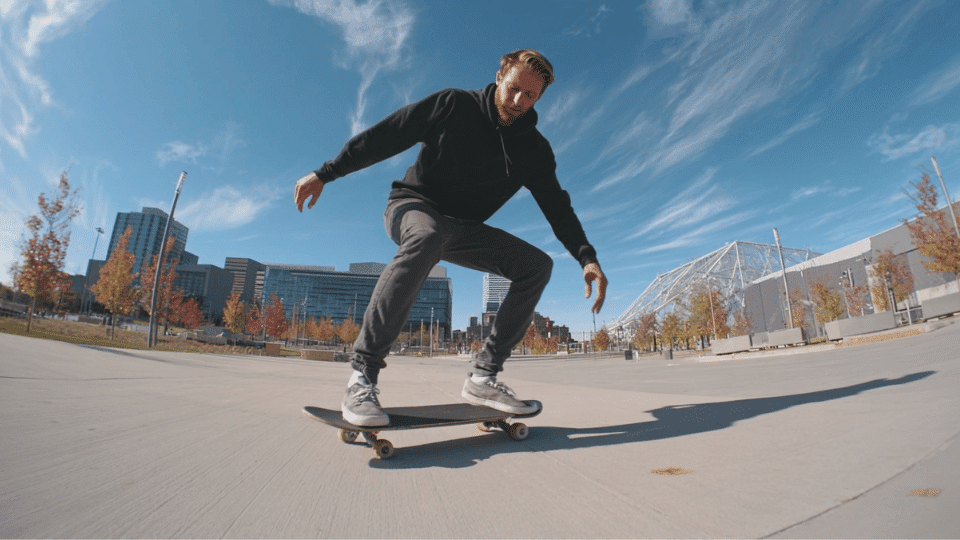 making a smooth wide turn on a skateboard in an open flat area