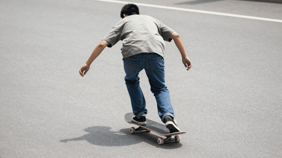 skateboarder riding on a city road in daylight . (1)
