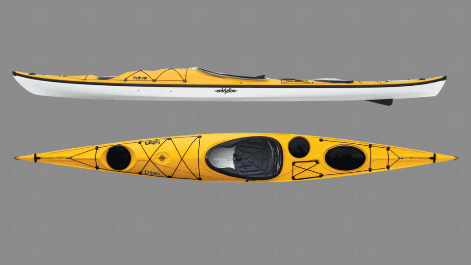 Yellow Eddyline Fathom touring kayak with long narrow hull and dual storage hatches