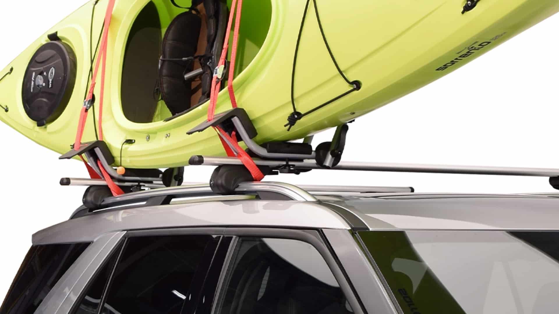 A lime green kayak secured to Malone AirFlow2 Crossbars on the roof rack of a silver SUV.