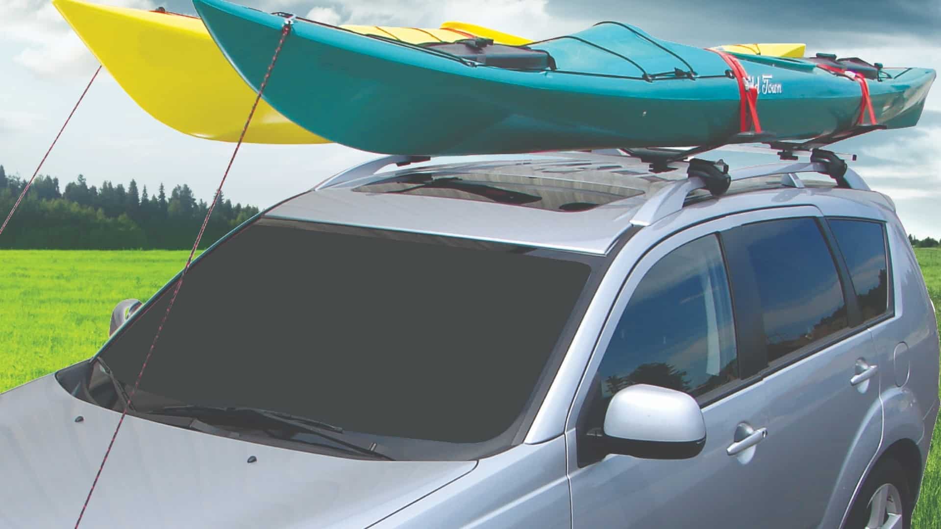 Two kayaks on a Malone SeaWing roof rack system atop a silver SUV.