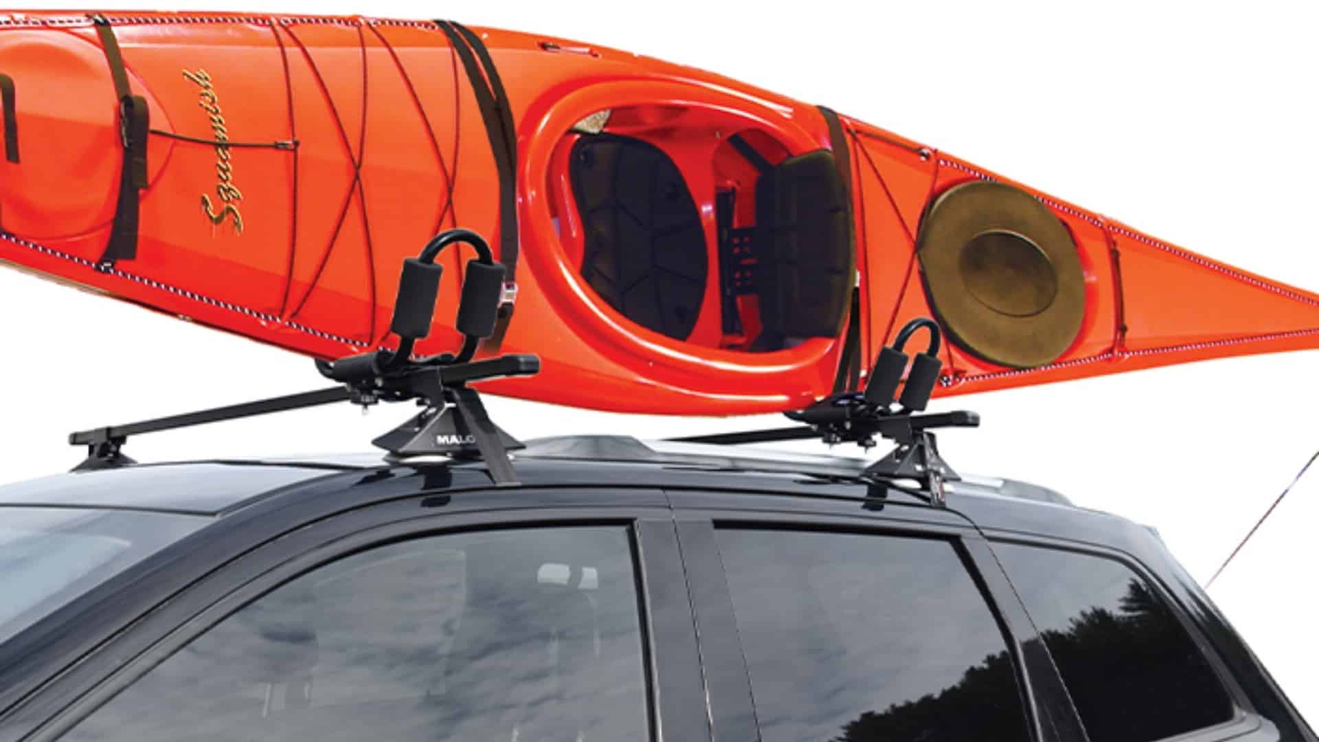 An orange kayak mounted on a Malone VersaRail Bare Roof Cross Rail System on a black SUV.