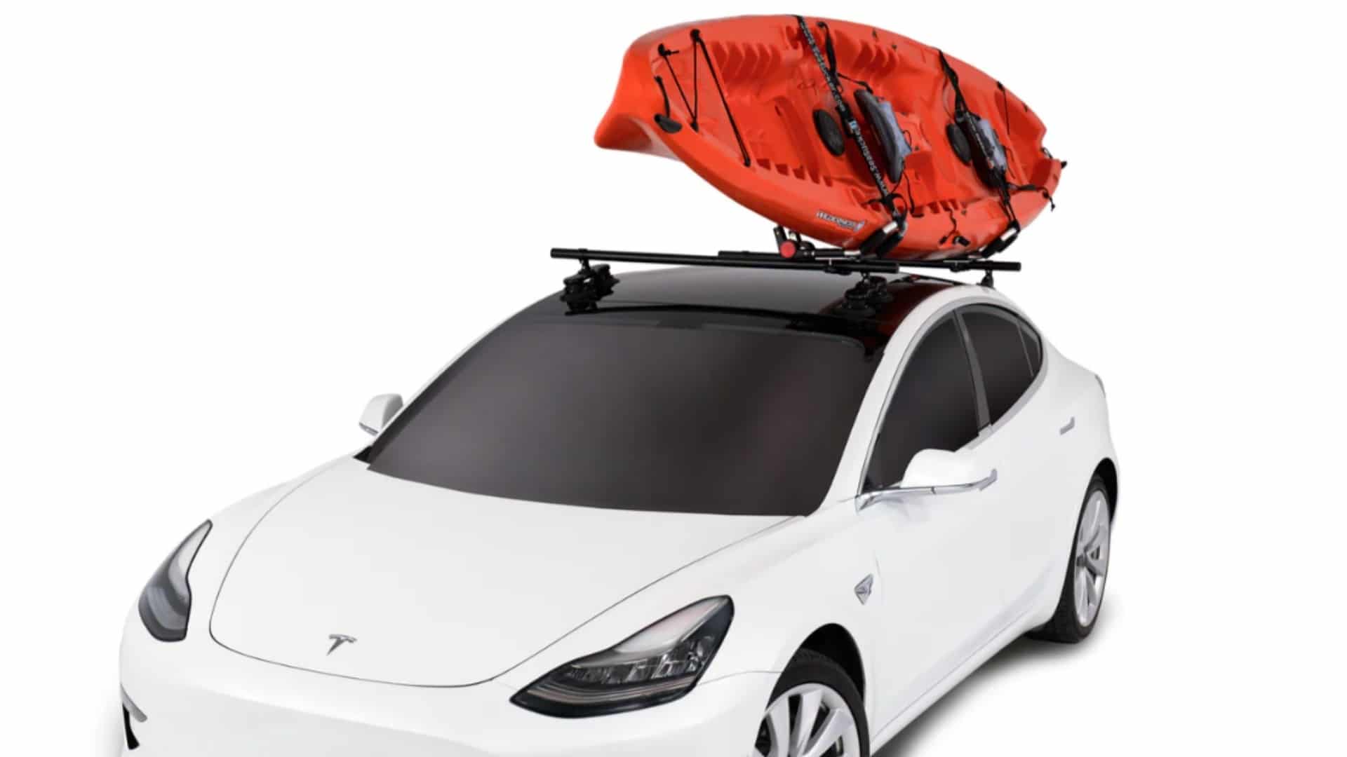 An orange kayak mounted on SeaSucker Monkey Bars on the glass roof of a white Tesla.