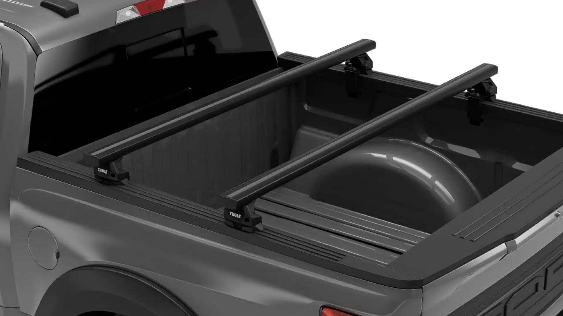 Two black Thule crossbars mounted onto the bed rails of a grey pickup truck.