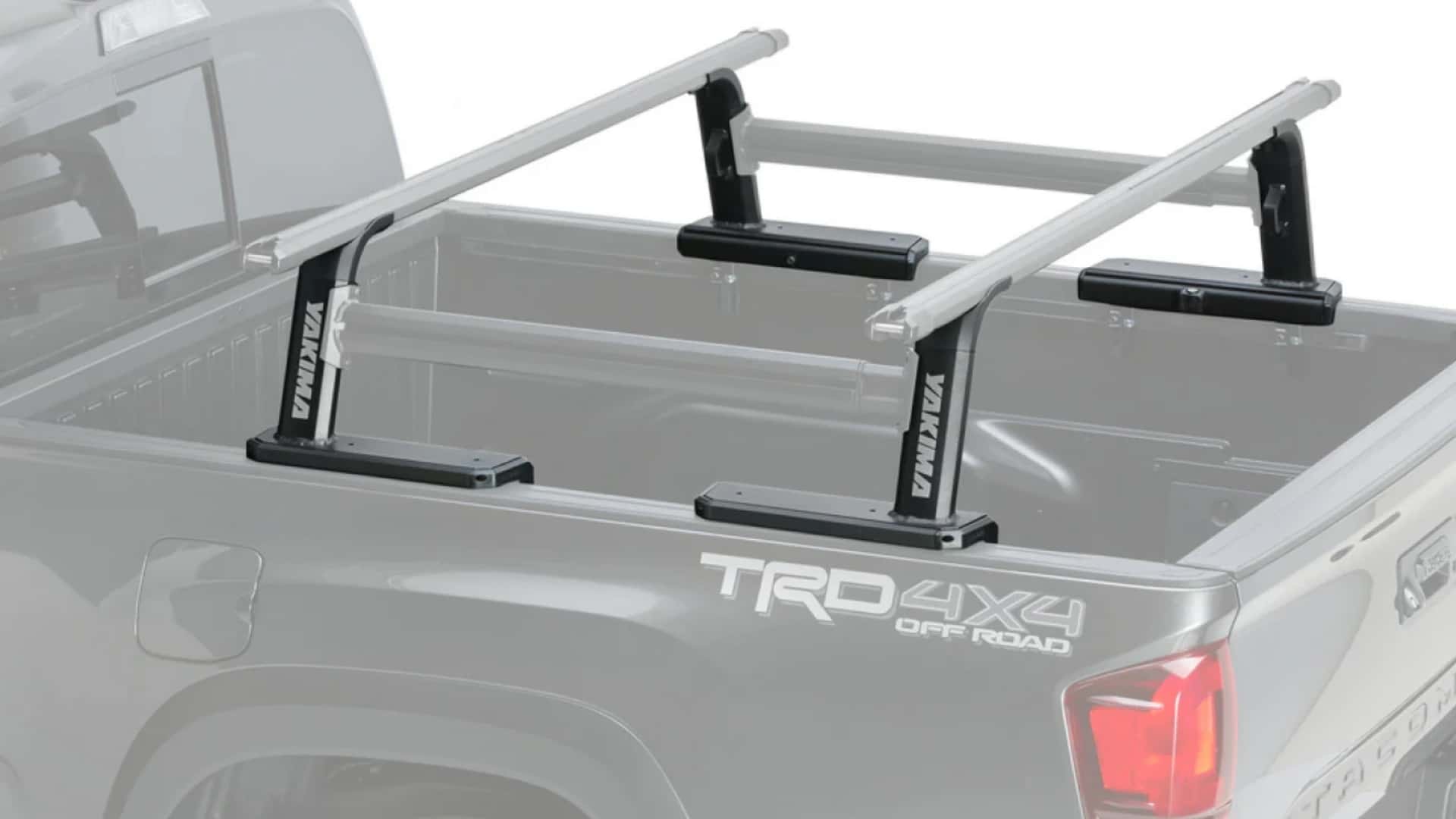 A Yakima OutPost HD mid-height truck bed rack system mounted on a grey TRD 4x4 pickup truck.