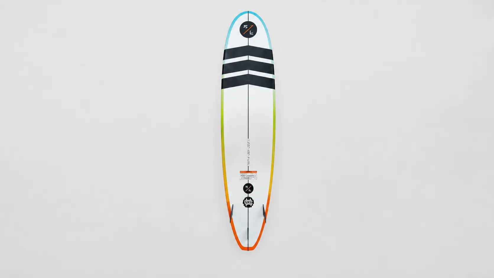 White Costco surfboard with black deck stripes and colorful rails displayed vertically on a clean studio backdrop