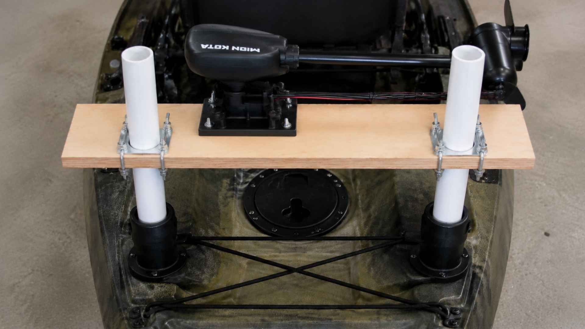 Trolling motor clamped onto finished board on kayak ready for water test