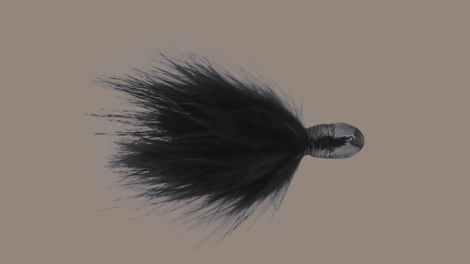 Outkast Feider Fly hair jig with flowing marabou strands on a plain background