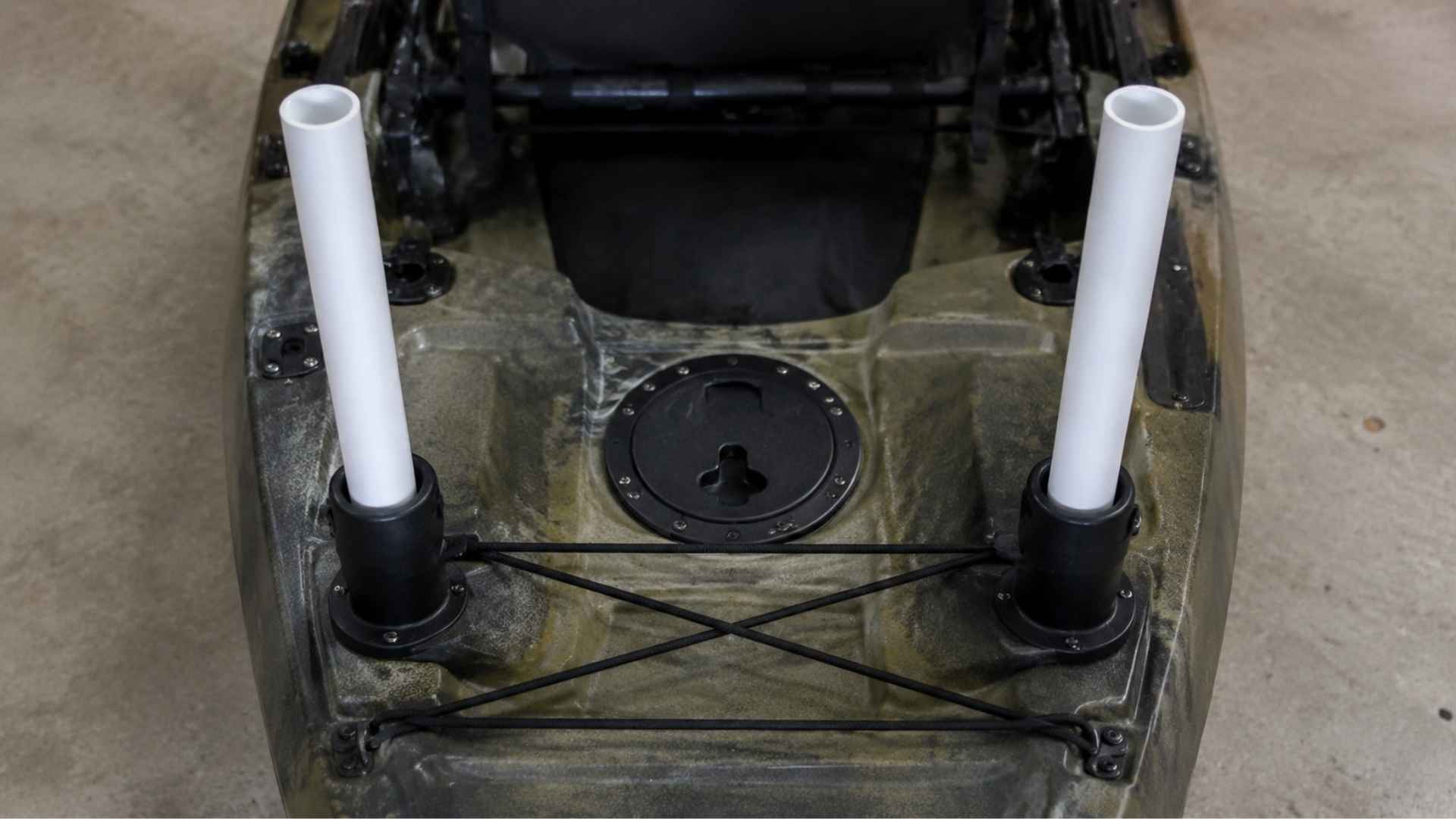 PVC pipes placed in rod holders on kayak stern DIY trolling motor base setup