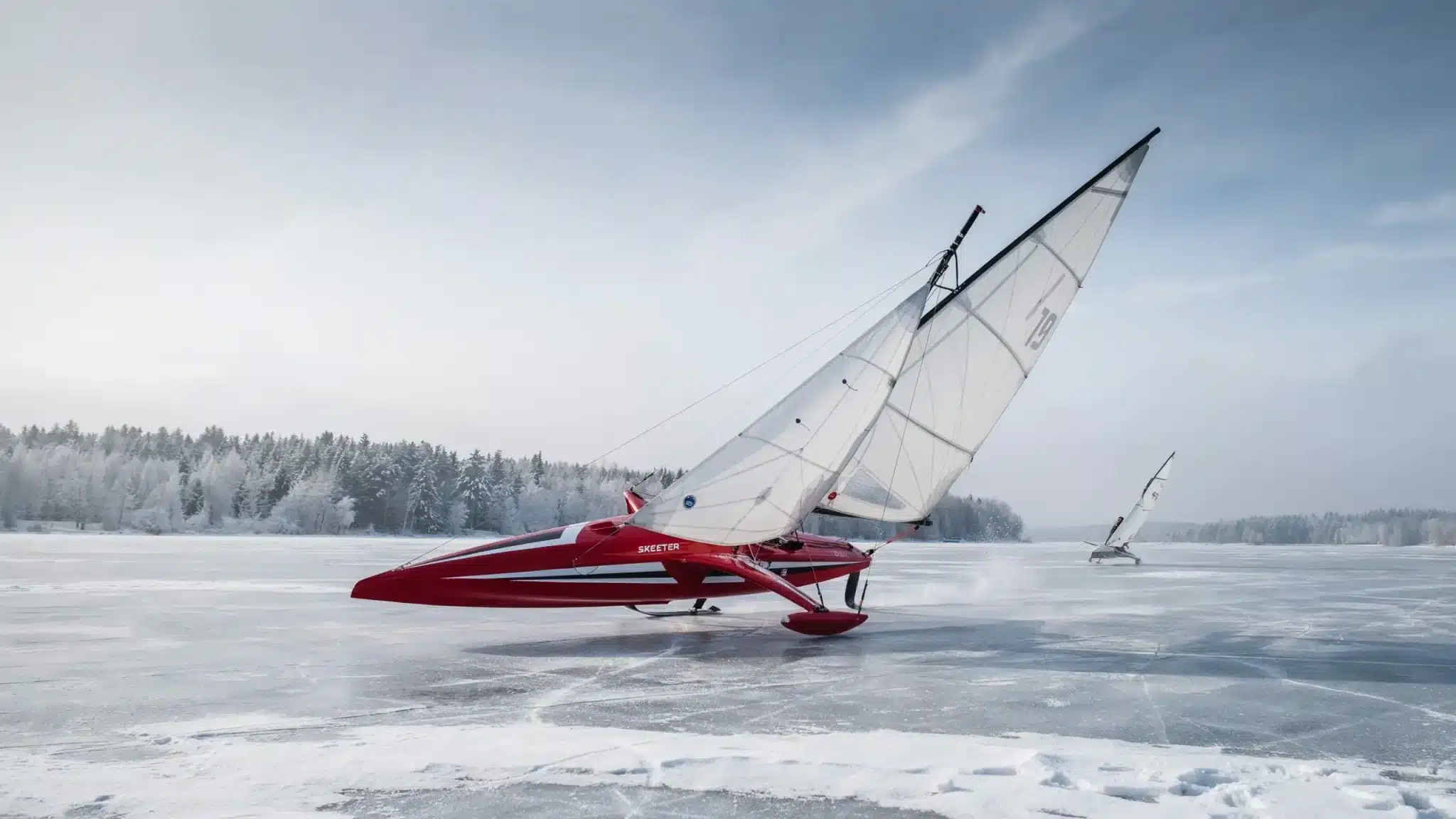 Large Skeeter iceboat with aerodynamic hull racing across a frozen lake at high speed
