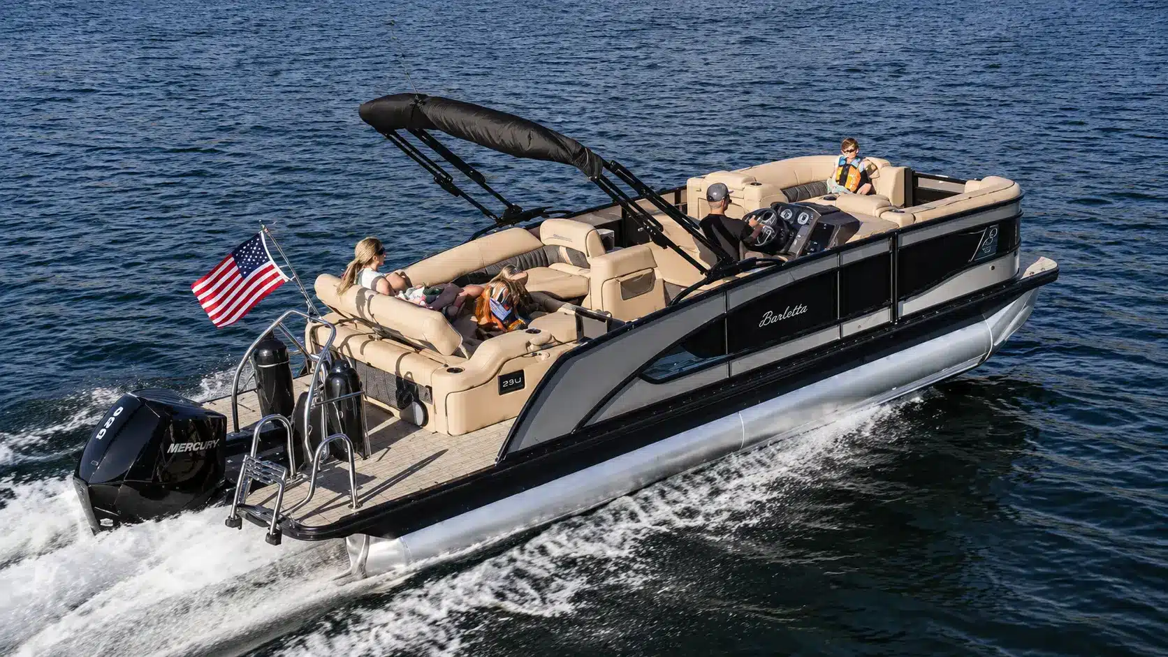 Barletta pontoon boat cruising across a lake