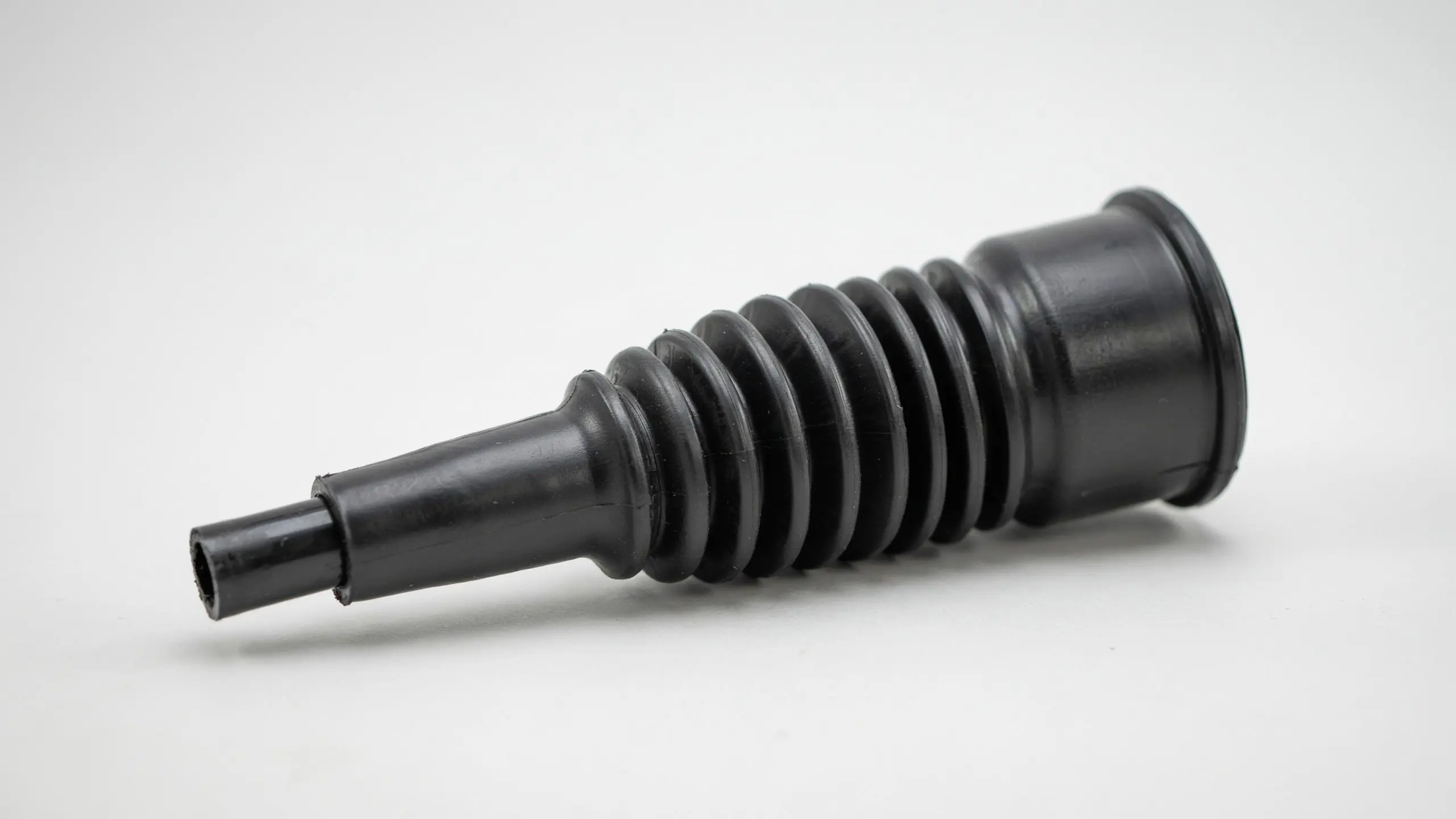 Black shift cable bellows part displayed on a clean background showing the ribbed flexible rubber construction and openings