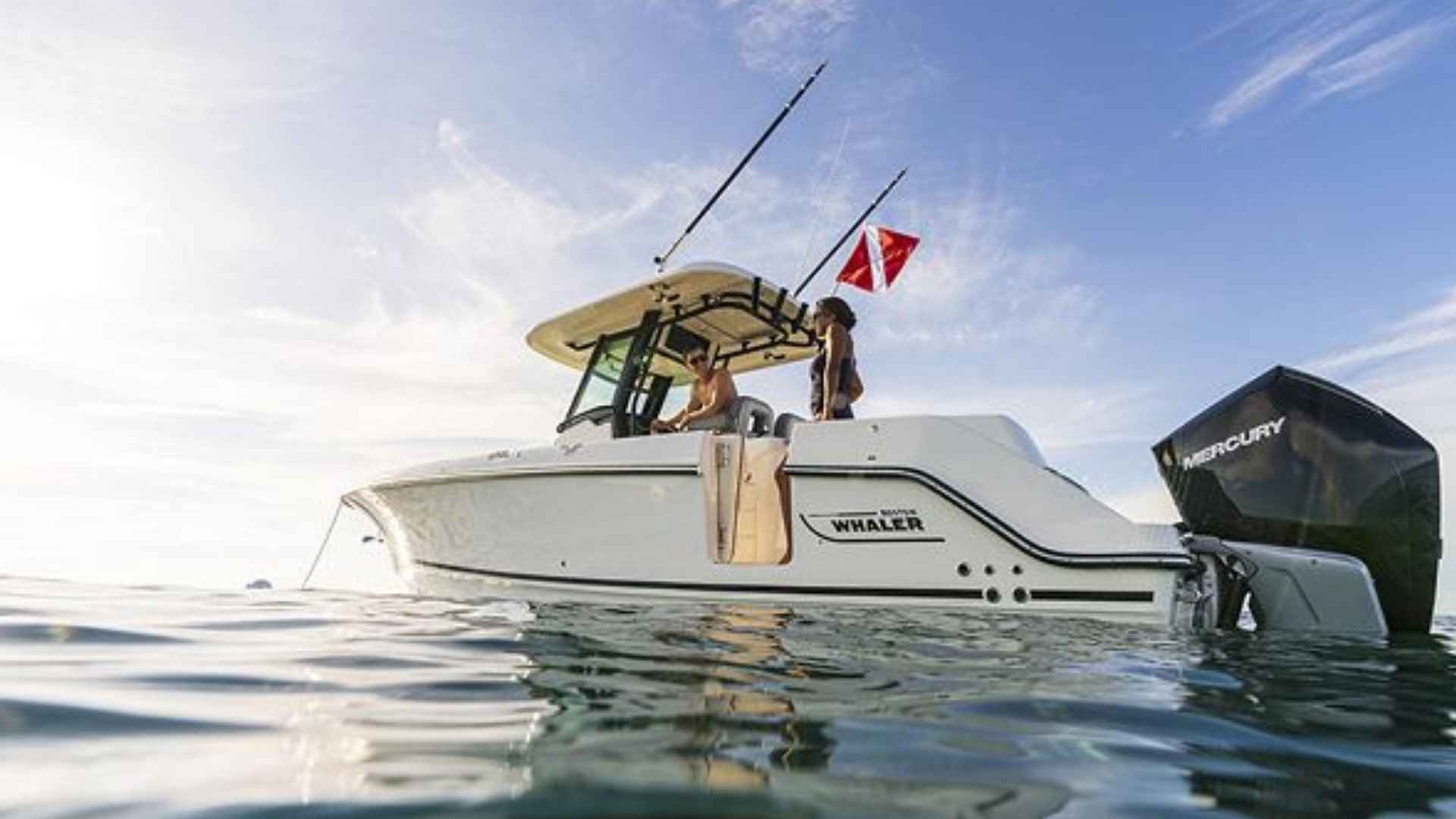 Boston Whaler 280 Outrage center console boat with twin outboard engines on water