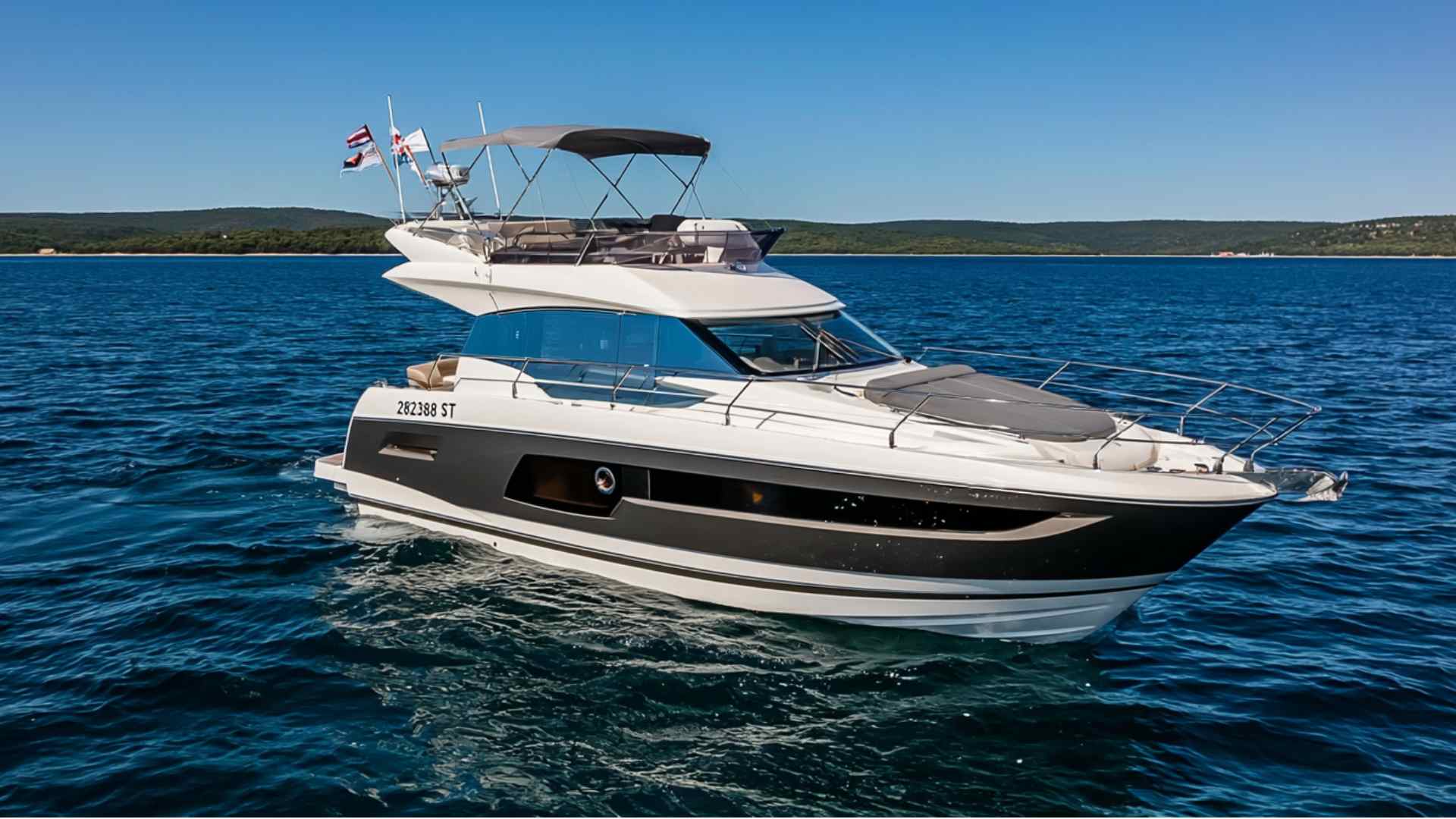 Cabin cruiser traveling across a lake with an enclosed cabin