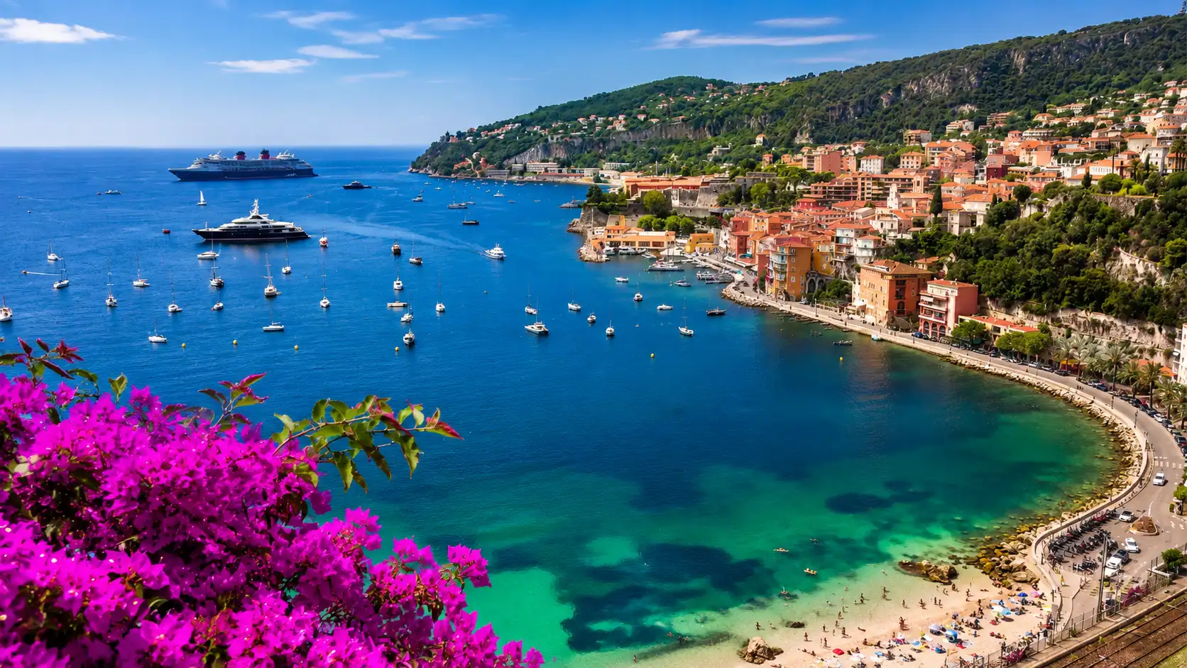 French Riviera with turquoise bay boats and hillside buildings under bright blue sky with flowers in foreground