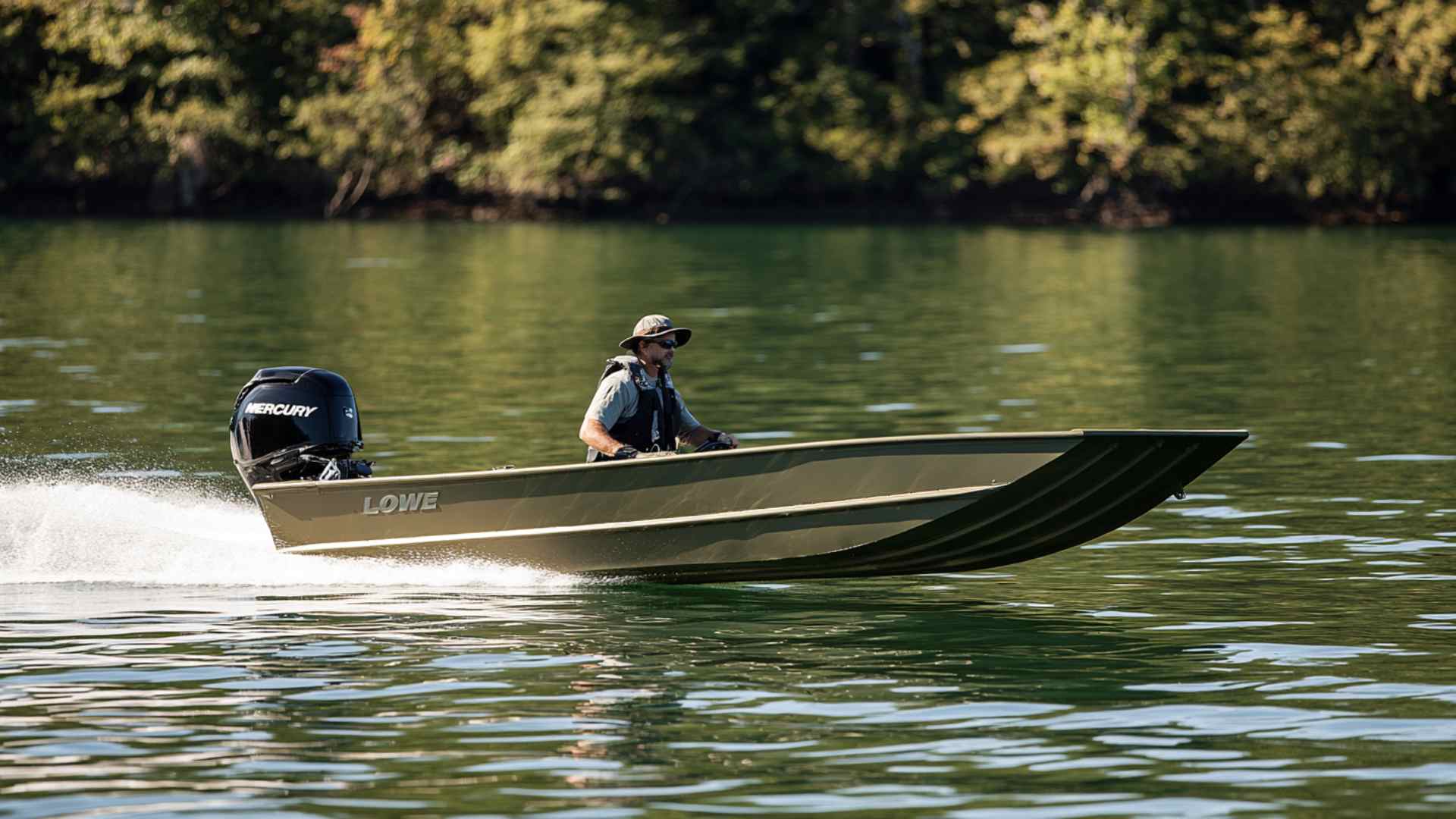 Jon boat navigating shallow water near a quiet lake shoreline