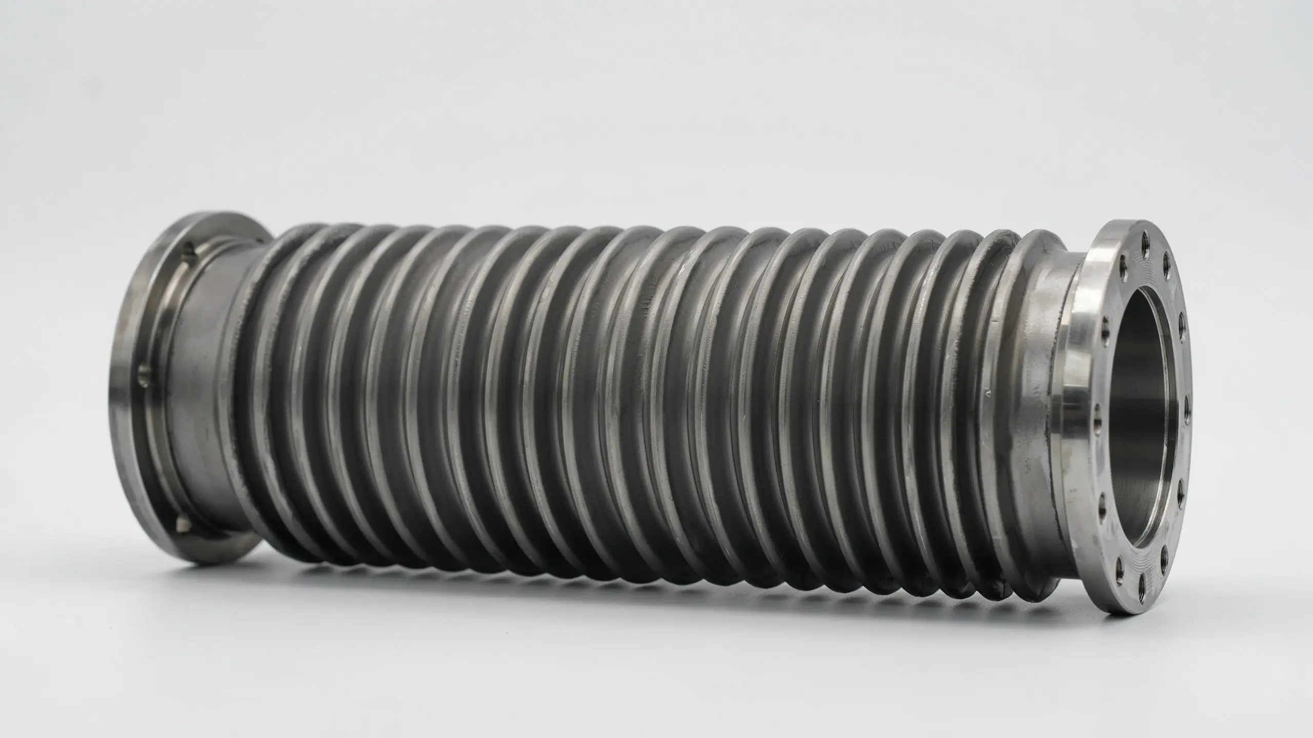 Marine exhaust bellows component shown with ribbed rubber body and metal mounting rings for boat exhaust connection use