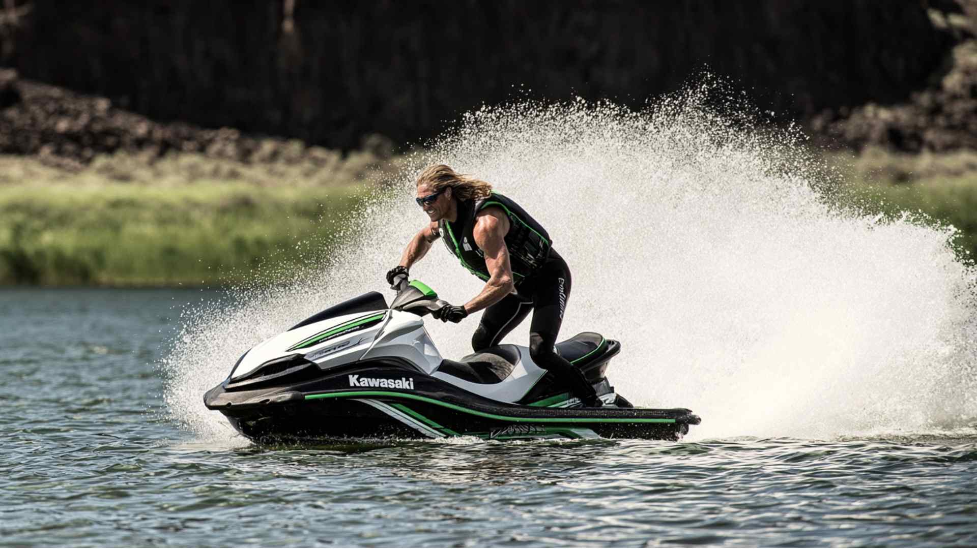 Personal watercraft rider traveling across a calm lake