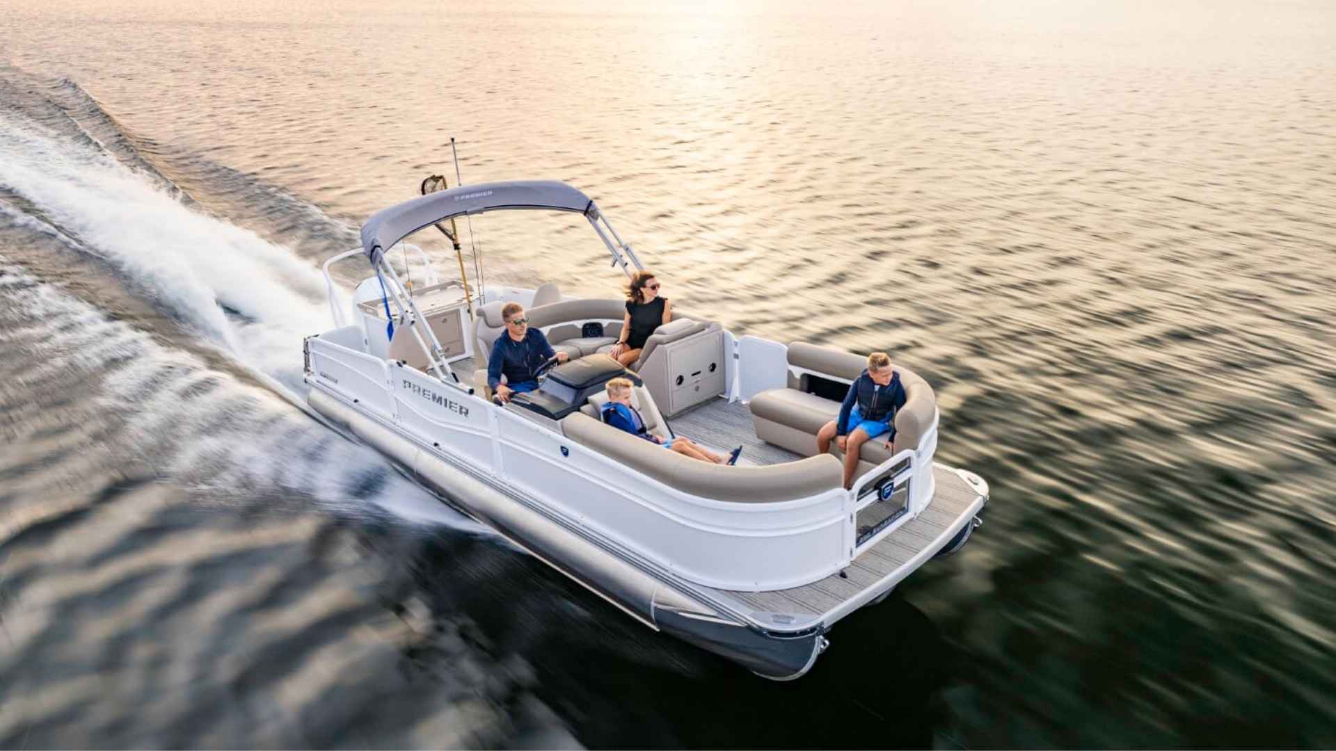 Premier pontoon boat with luxury interior cruising on water