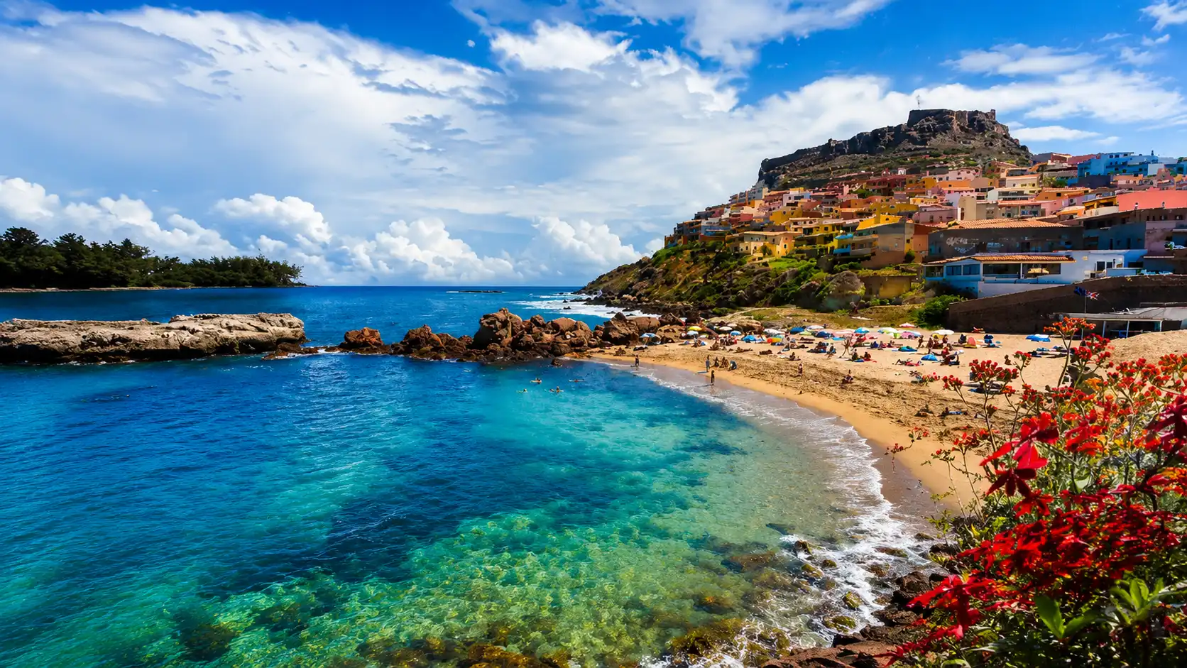 Sardinia with turquoise sea, colorful hillside houses, rocky coastline and sunny coastal scenery