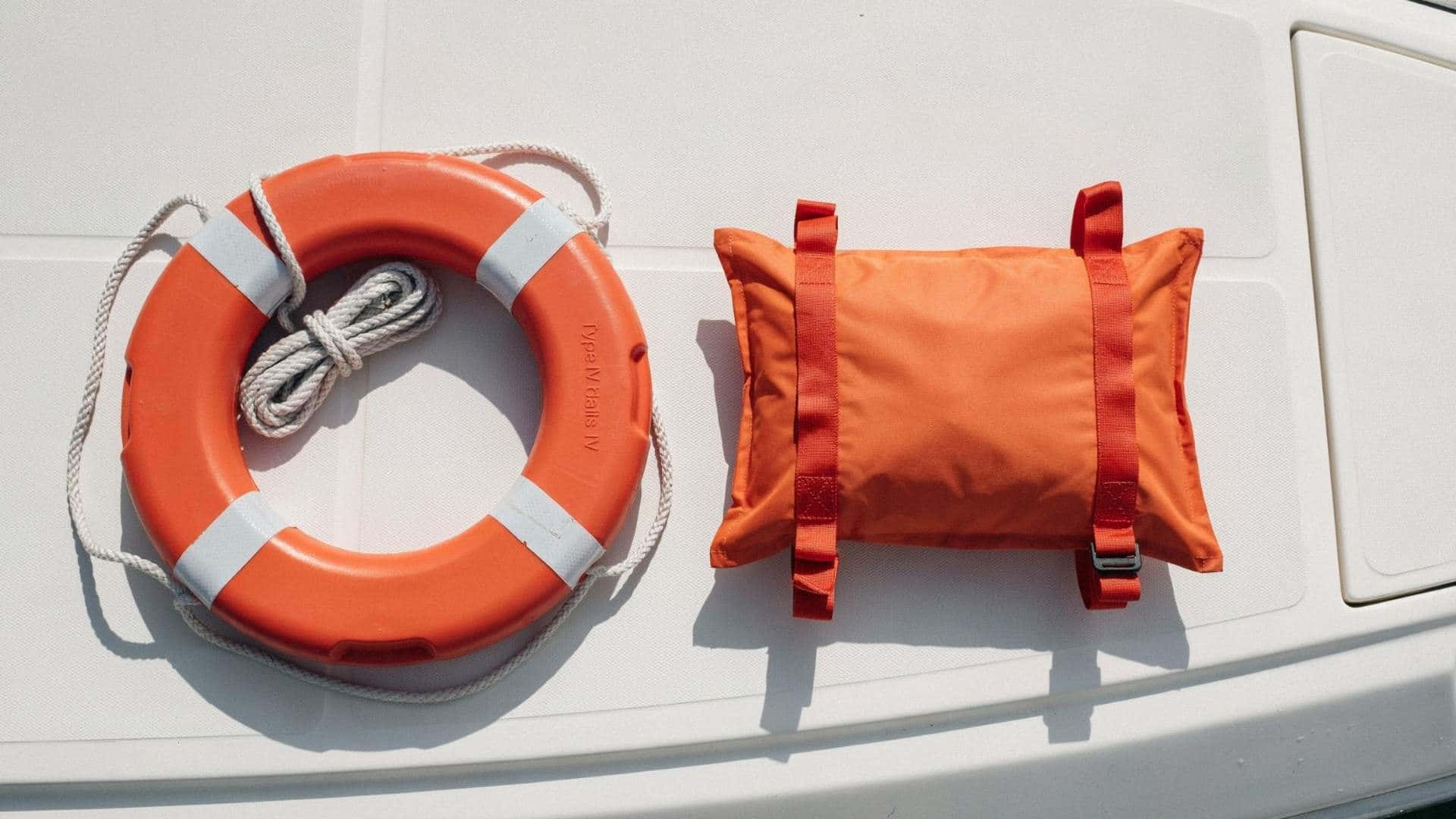 Type IV PFD throwable flotation cushion and life ring placed on a boat deck for water safety.