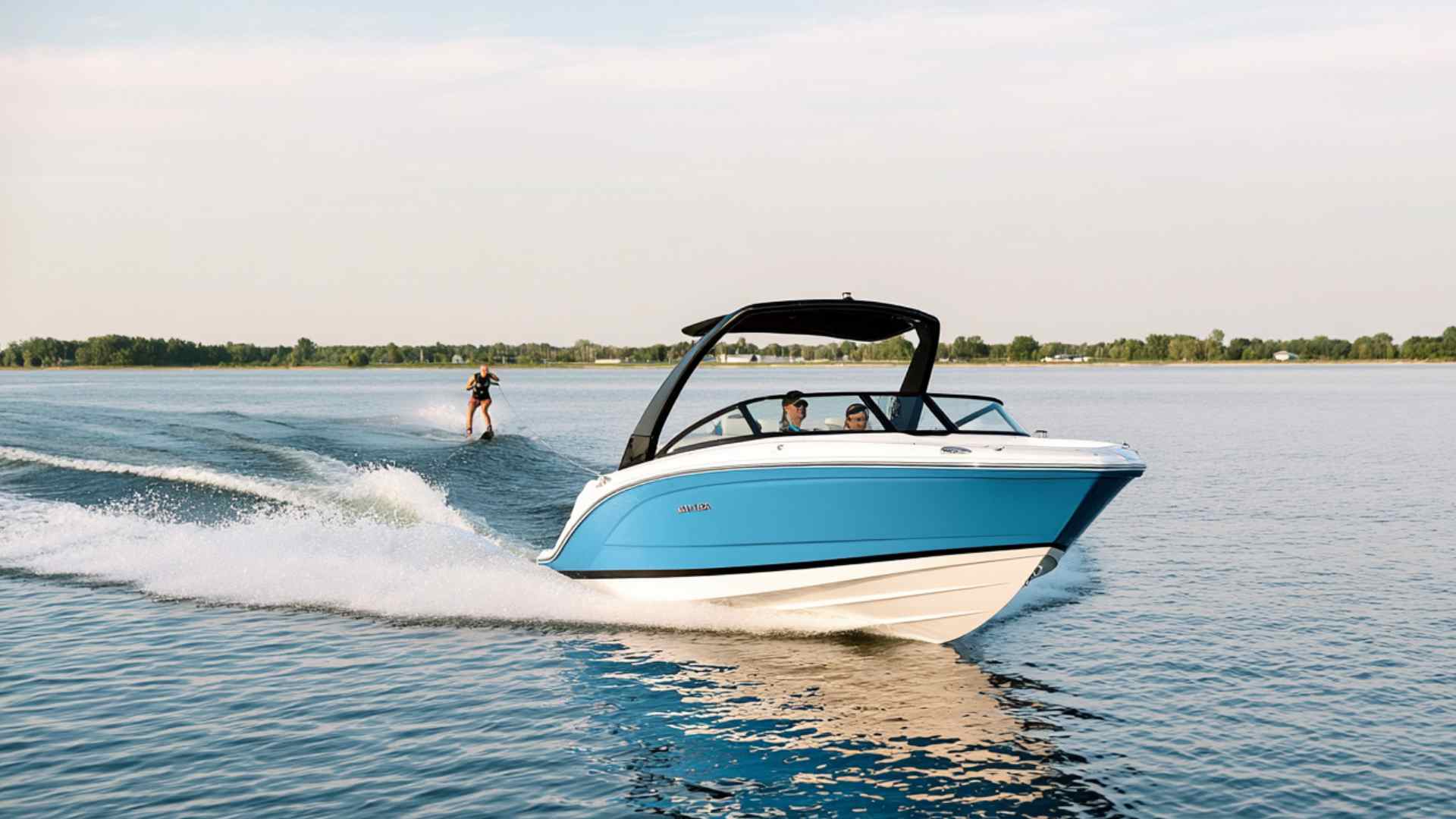 Watersports boat towing a wakeboarder across a lake