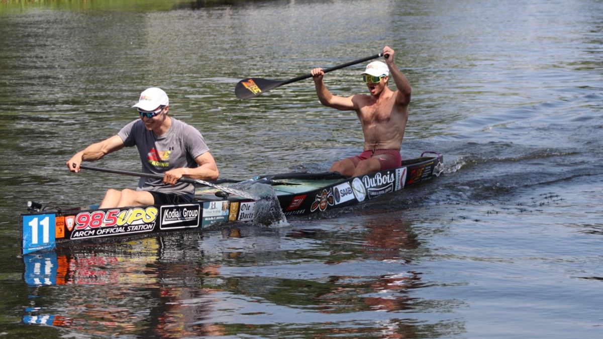 AuSable River Canoe Marathon paddlers competing in a canoe race on the river during the endurance event