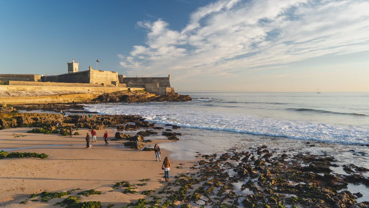 Cascais coastline in Portugal with rocky shore, Atlantic waves, and historic seaside fortress