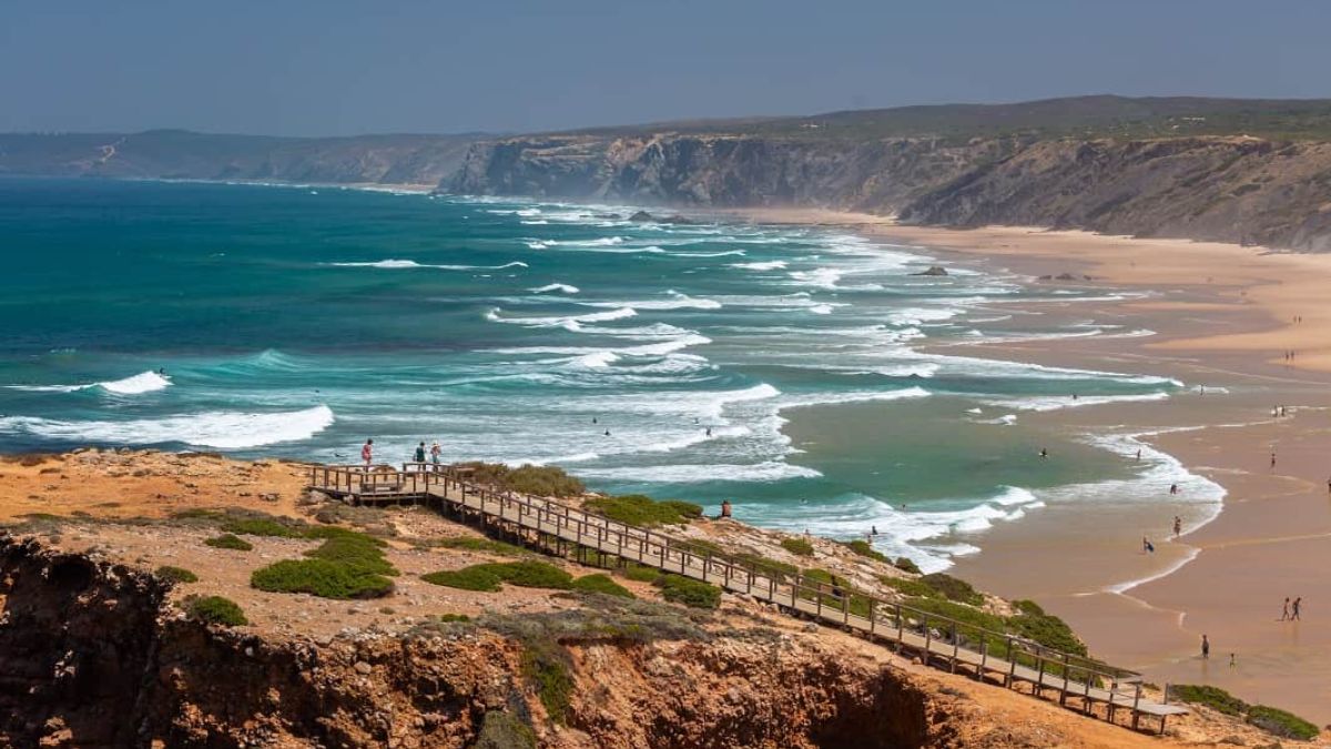 Costa Vicentina coastline in Portugal with cliffs, sandy beach, and Atlantic waves for surfing