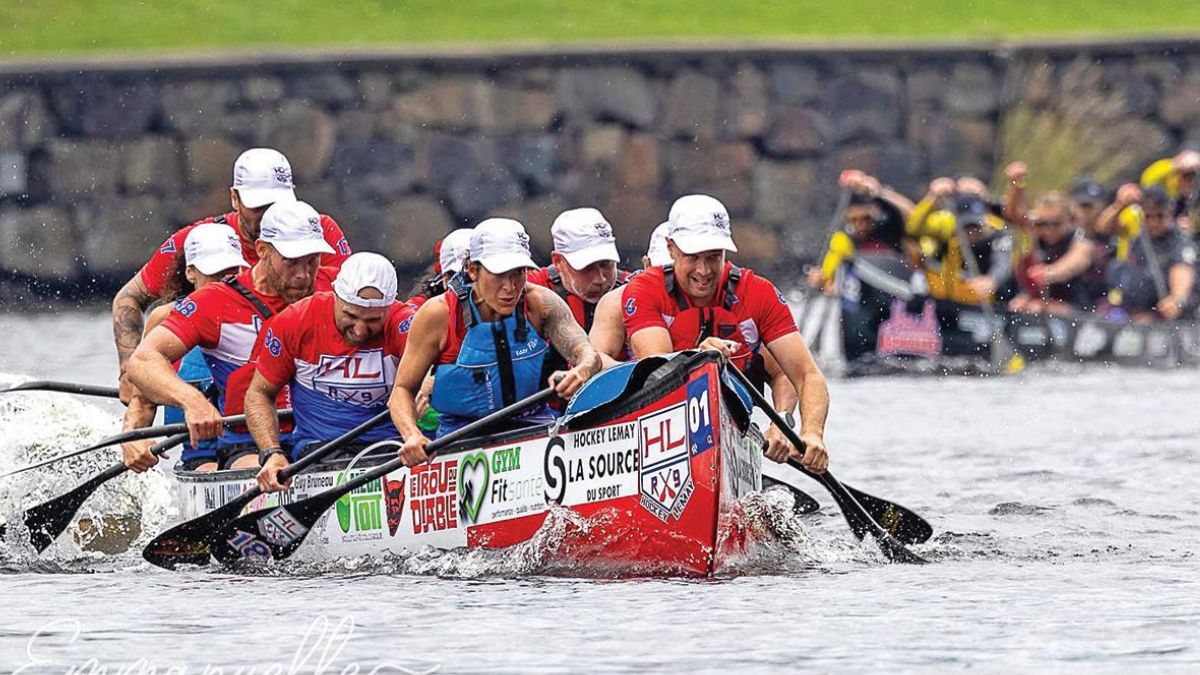 AuSable River Canoe Marathon paddlers racing in canoes through the river during a competitive endurance event.